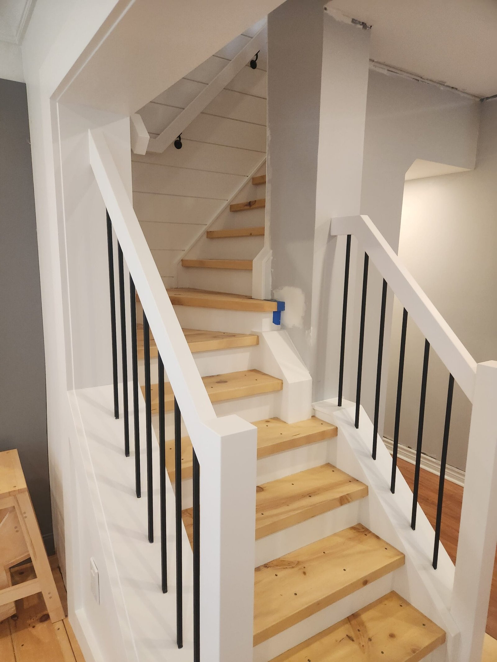 Custom staircase with wood treads and metal spindles Ontario
