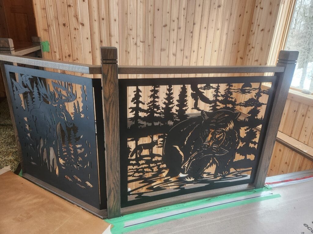 Custom decorative metal railing panels with wildlife scenes and wood posts