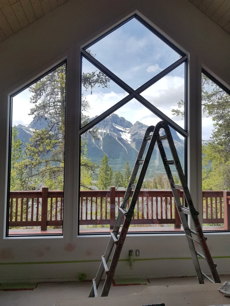 Vaulted ceiling with custom peaked window trim framing mountain view
